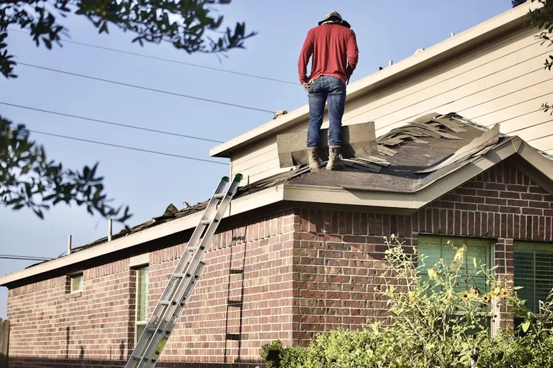 Professional roofer working on a residential roof in Quiet Place In The Country